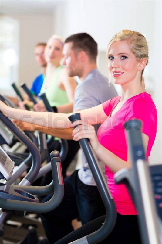 Group of fitness people in sport gym on treadmill, stock photo