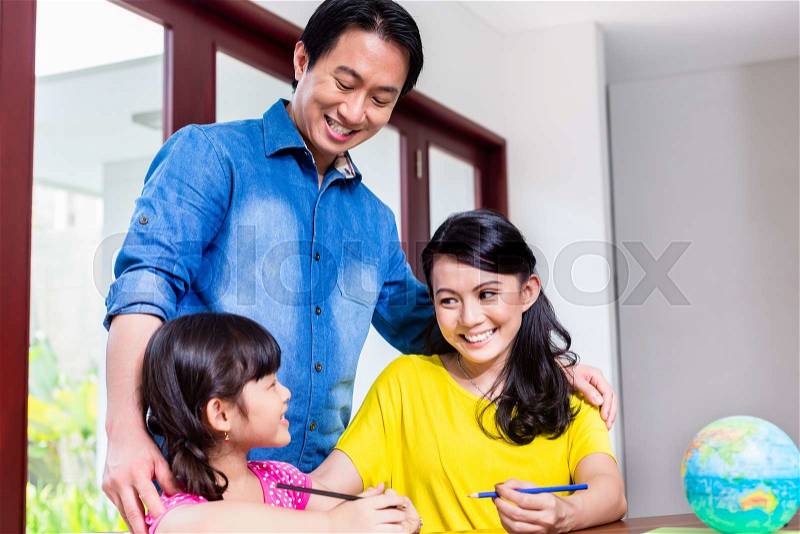 Chinese family learning mathematics with her child, stock photo