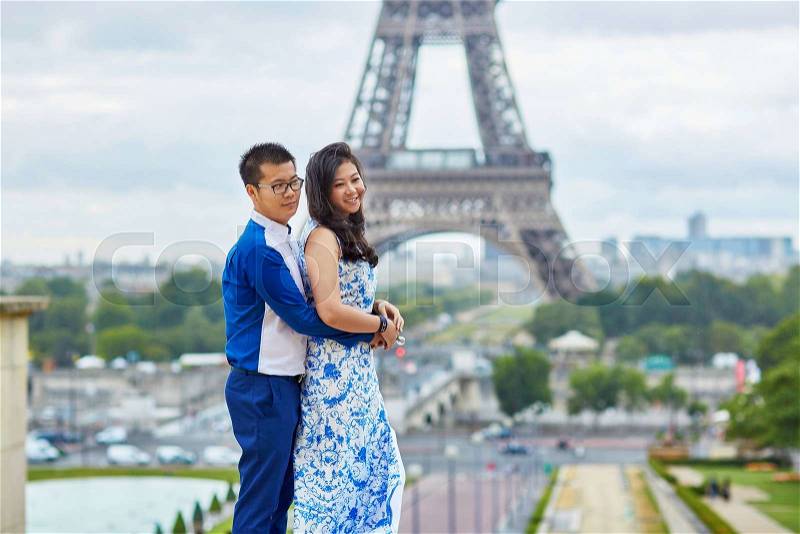 Young romantic Asian couple on Trocadero view point near the Eiffel tower in Paris, France, stock photo