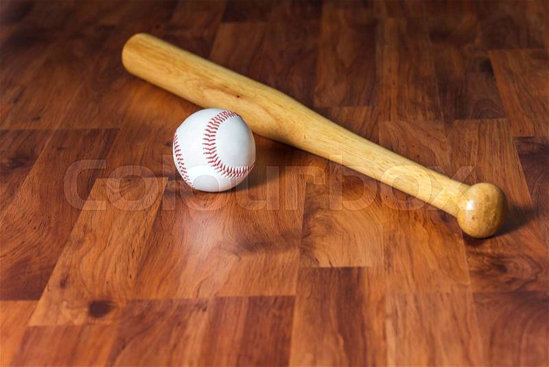 Baseball bat with ball on wood background, stock photo