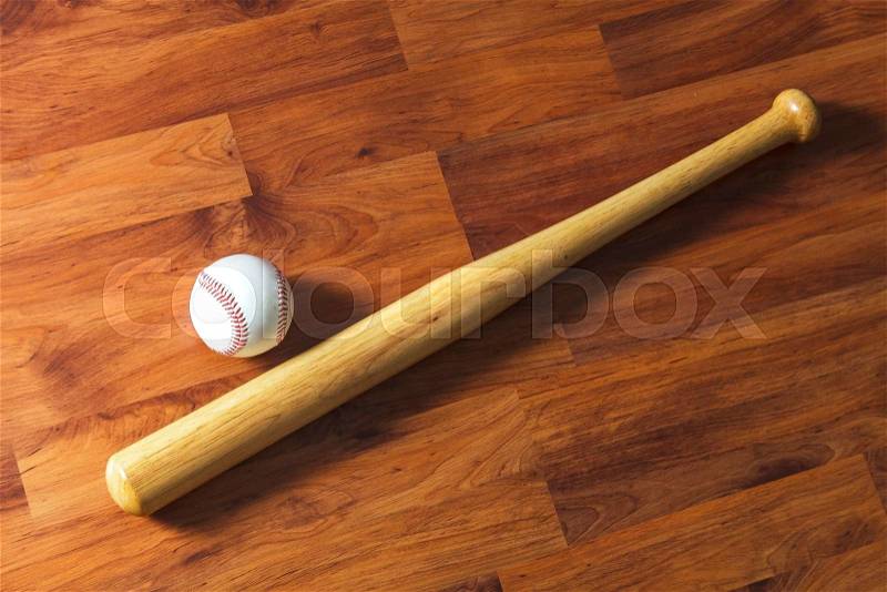 Baseball bat with ball on wood background, stock photo
