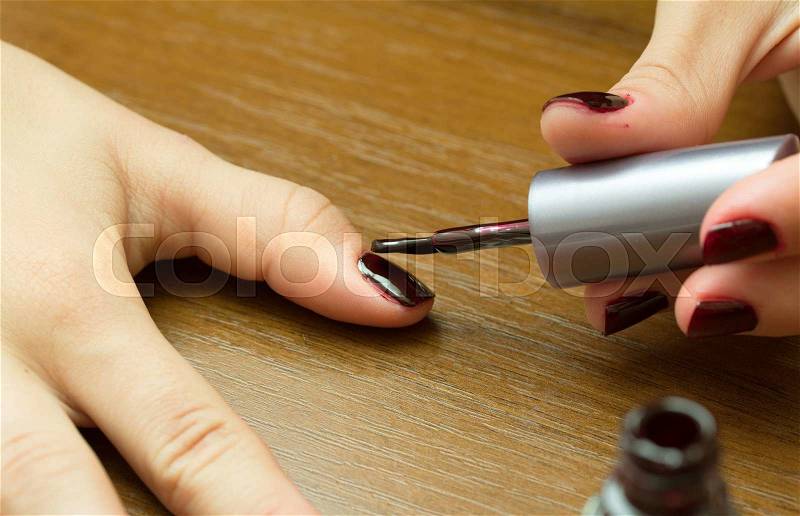 Painting fingernails with varnish, stock photo