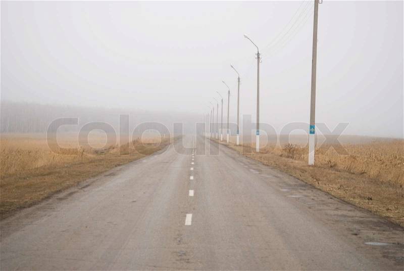 Foggy country road in nothern Kazakhstan, stock photo