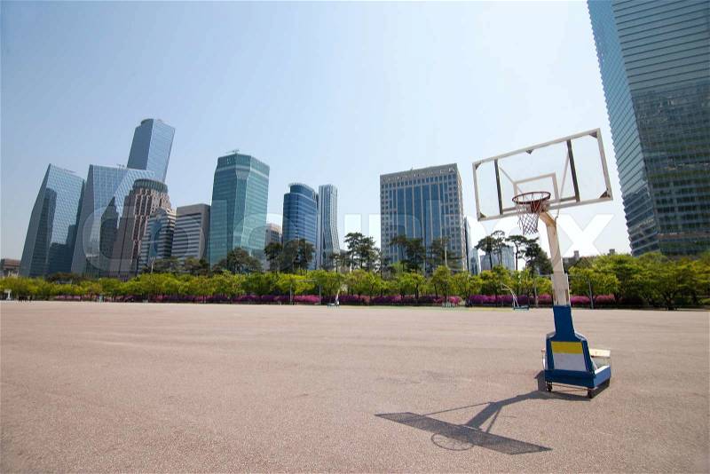 Streetball court in park area near office buildings in Seoul, Korea taken with wide angle lens, stock photo