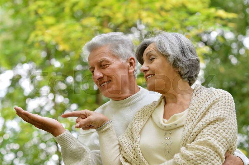 Loving mature couple on a walk in the park in summer, stock photo