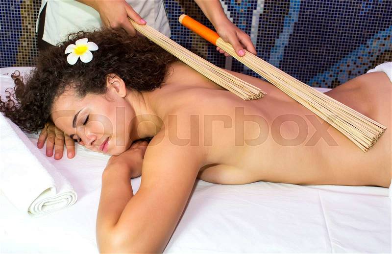Japanese massage with bamboo sticks in the spa salon, stock photo