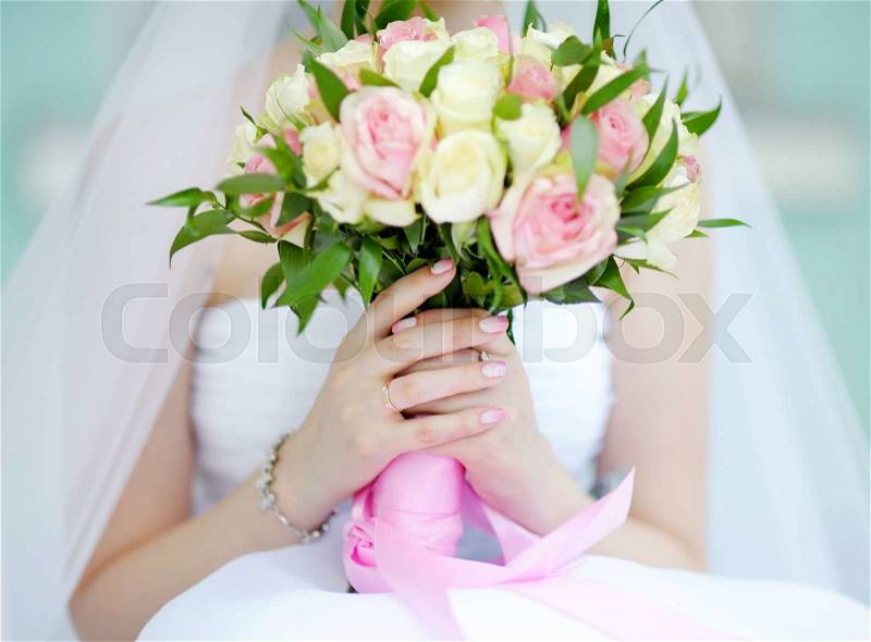 Bride holding wedding flowers roses bouquet, focus in hand and wedding ring, stock photo