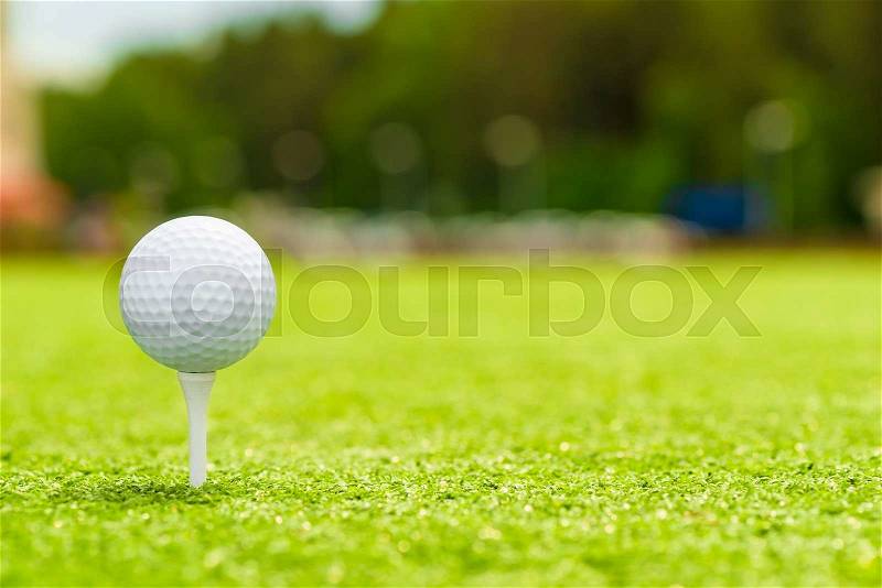 Golf ball on the tee is the right space for inscription, stock photo