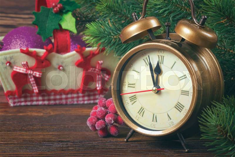 New Year clock and fir branches with Decorative basket with deer. Filtered in retro style, stock photo
