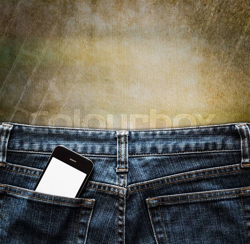 Blue jeans with cell phone in a pocket on vintage background, stock photo