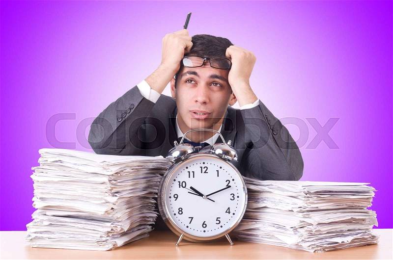 Woman businessman with giant alarm clock, stock photo