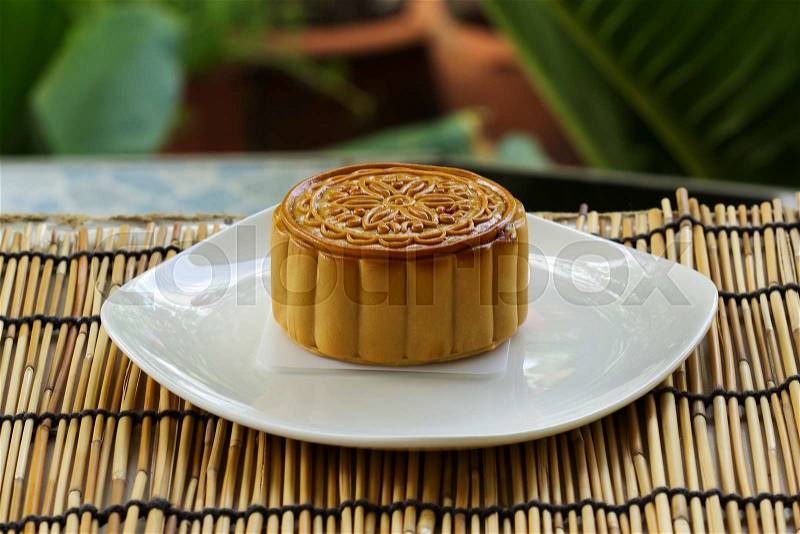 Moon cake with durian and egg yolk filling on the plate, stock photo