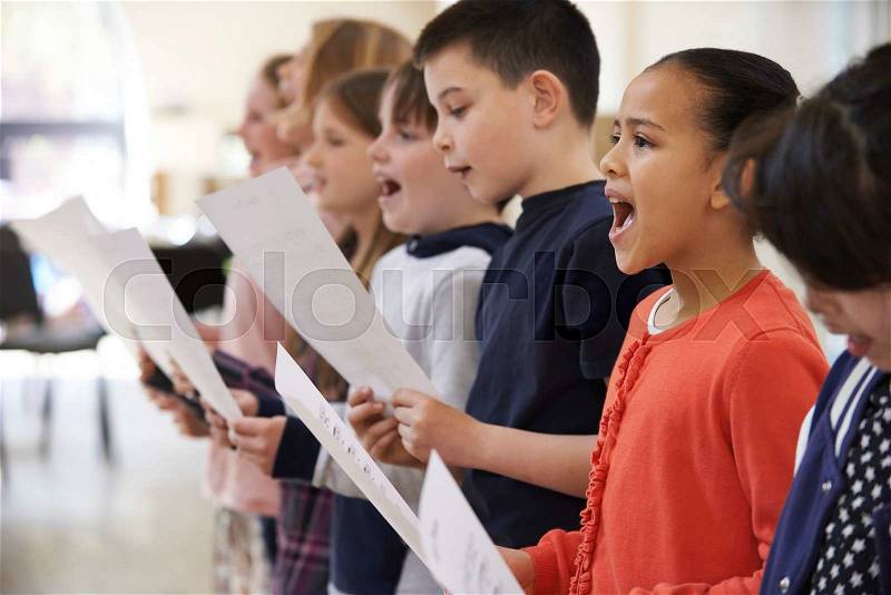 Group Of School Children Singing In Choir Together, stock photo