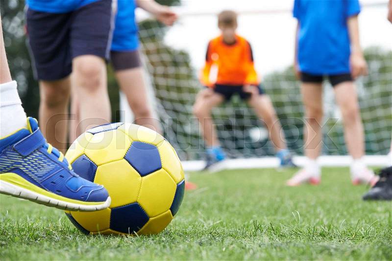 Close Up Of Children\'s Feet In Soccer Match, stock photo