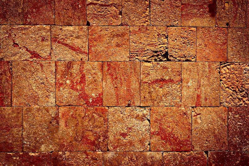 Texture of stone wall of ancient Mayan ruins in Mexico, stock photo