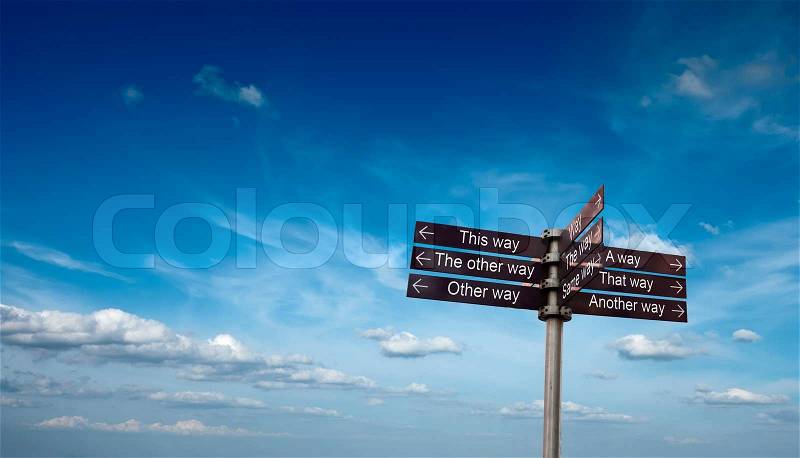 Signpost with directional signs in sky with clouds, stock photo
