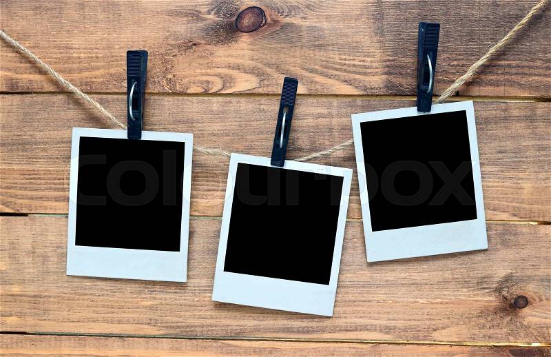 Empty polaroid photo frames on wooden background, stock photo