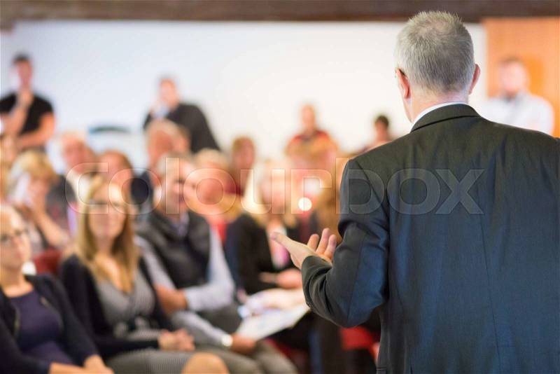 Speaker at Business Conference with Public Presentations. Audience at the conference hall. Entrepreneurship club. Rear view. Horisontal composition. Background blur, stock photo
