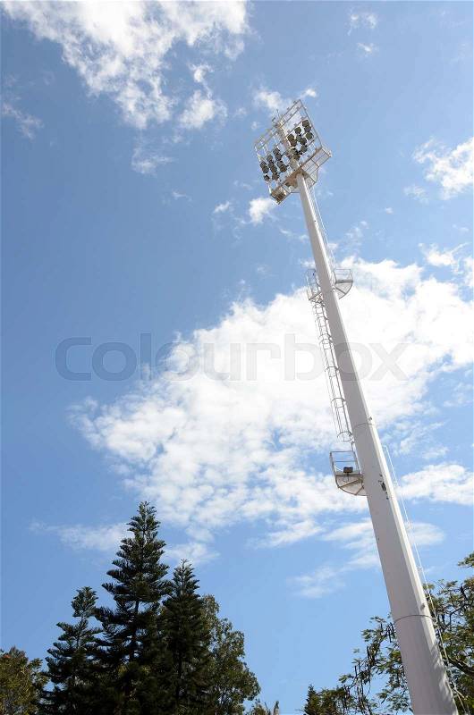 Stadium lighting pole on blue sky with cloud, stock photo