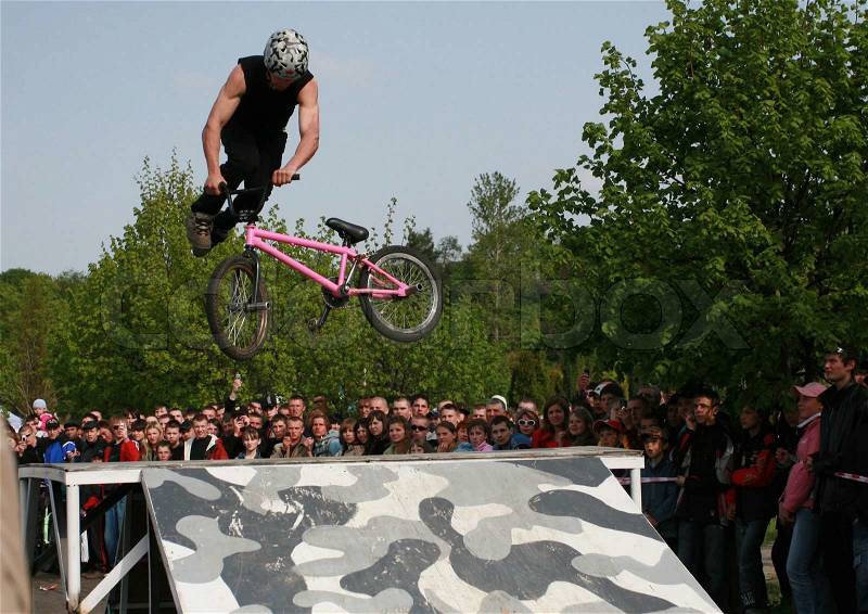 Eastern Europe, Ukraine May 6, 2007. Guys jump on a bike, stock photo