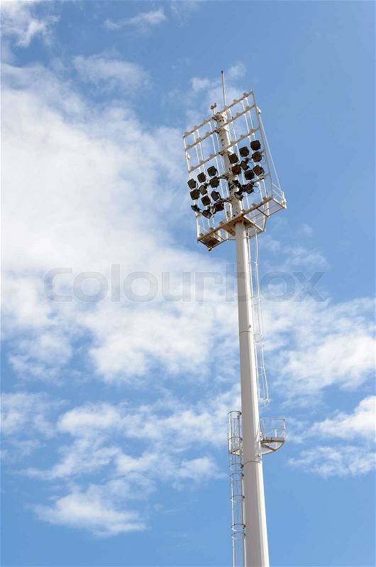 Stadium lighting pole on blue sky with cloud, stock photo