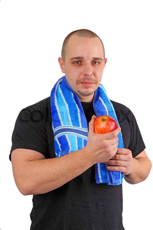 Young sportsman man holds red apple on white background, stock photo