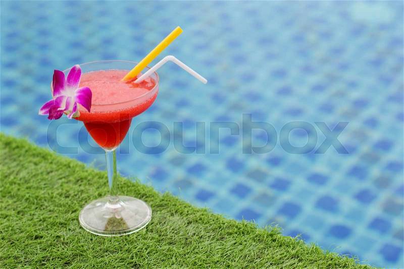 Frozen margarita with strawberry aperitif coctail near swimming pool, stock photo