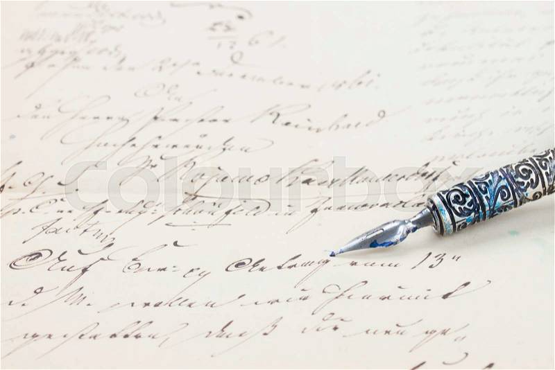 Old feather pen on handwritten letter background, stock photo