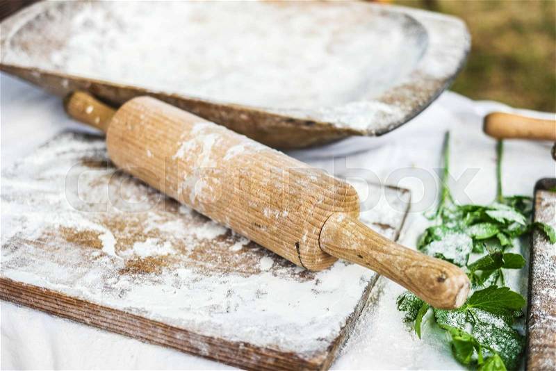 Working surface for dough with wooden board and rolling-pin, stock photo