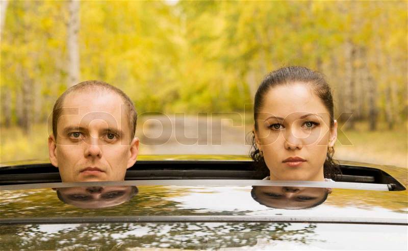 Sad couple in a car, stock photo