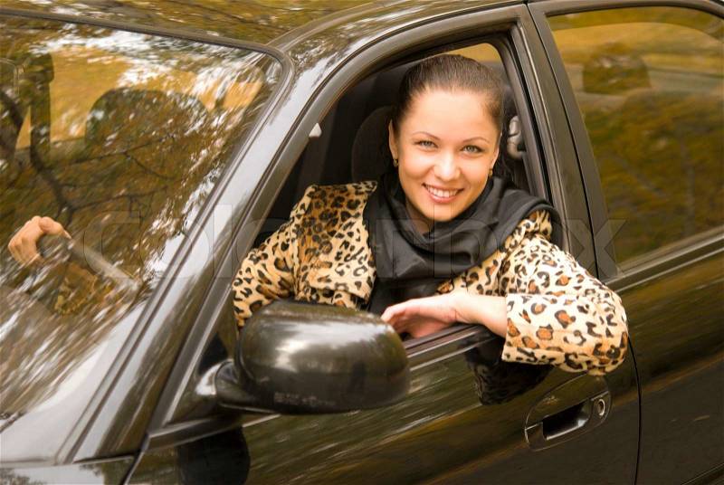 Young attractive businesswoman driving her car, stock photo