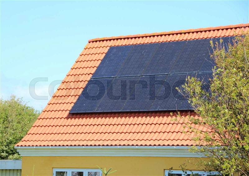Solar panel on House Roof with Red Tiles Saving Electricity, stock photo
