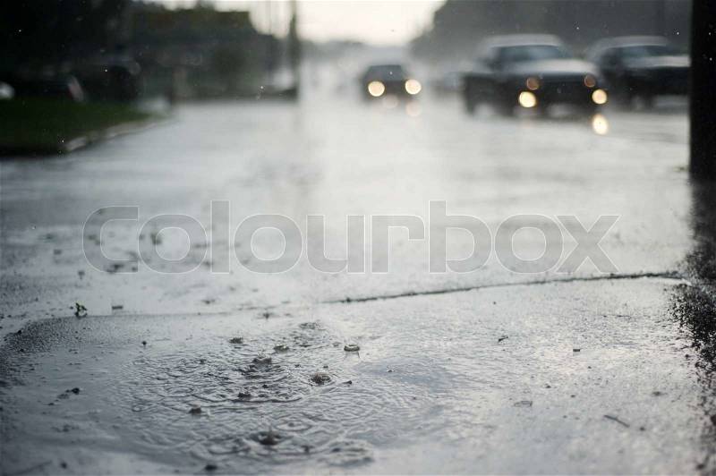 Puddle near the wet road in the rain, stock photo