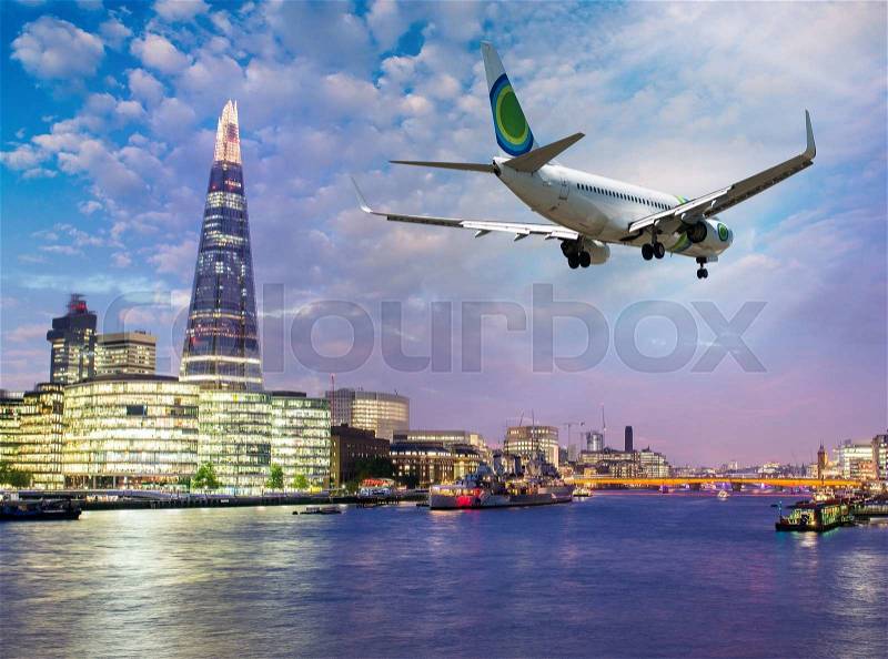 Airplane overflying London - Tourism and vacation concept, stock photo