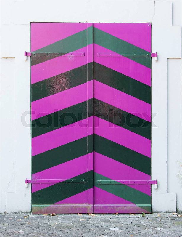 Old pink door of a building in Bern, Switzerland, stock photo