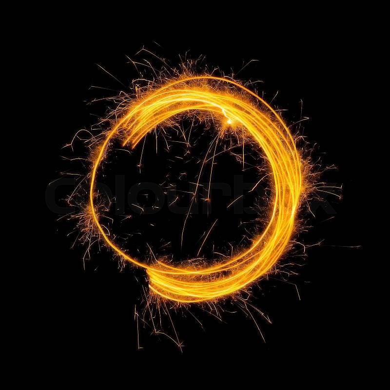 A sparkling glowing fire circle on a black background , stock photo