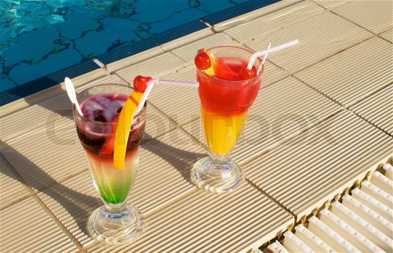 Two cocktails near swimming pool, stock photo