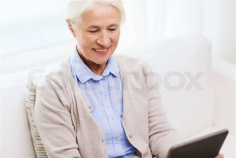 Technology, age and people concept - happy senior woman with tablet pc computer at home, stock photo