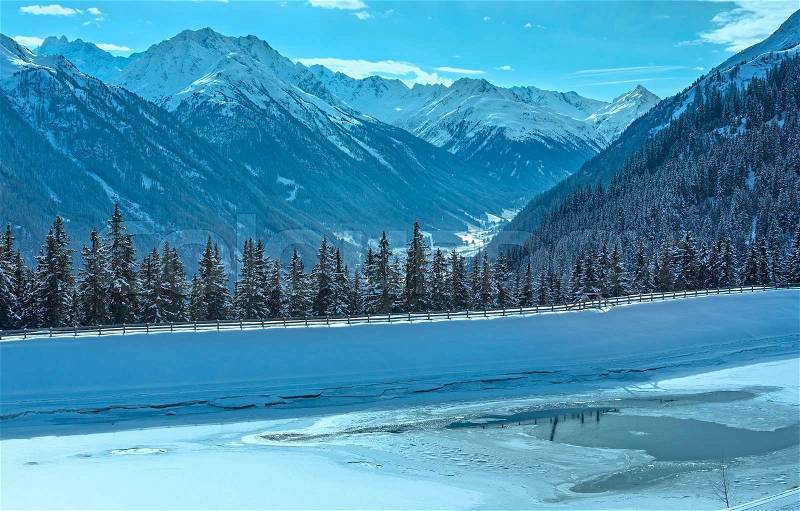 Winter mountain and thawing lake. Kappl ski region in the Tyrolean mountains, Austria, stock photo