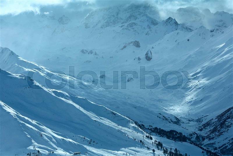 Winter Silvretta Alps cloudy snowfall landscape, Tyrol, Austria, stock photo