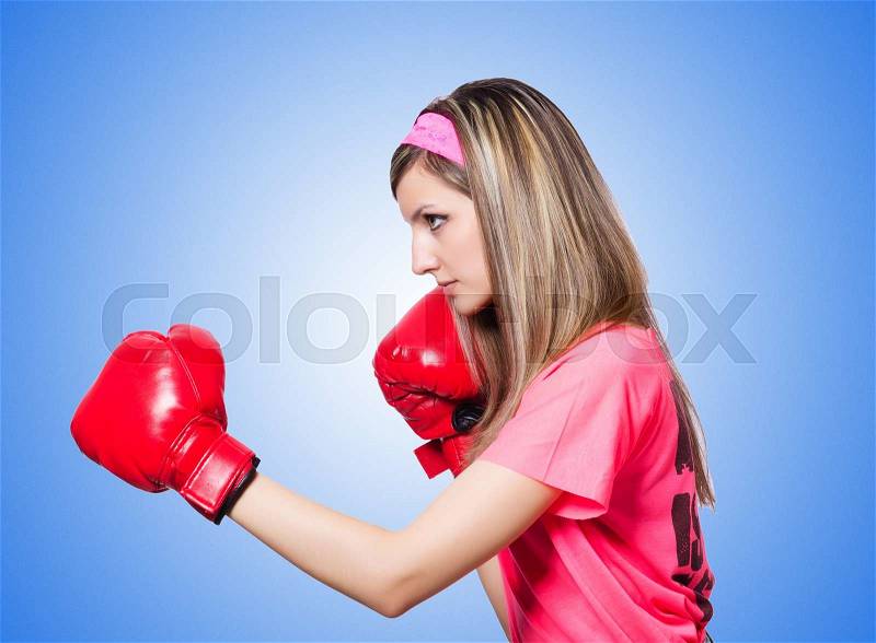 Young lady with boxing gloves on white, stock photo