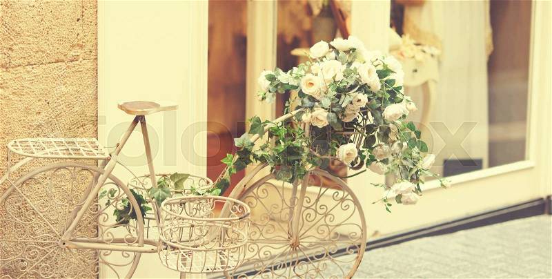 Vintage beautiful white vintage bicycle with flowers, stock photo