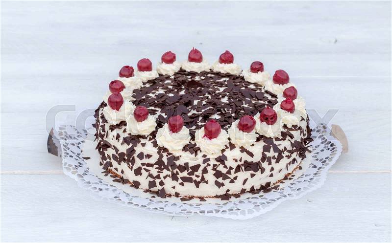 Black Forest cake on white wooden, stock photo