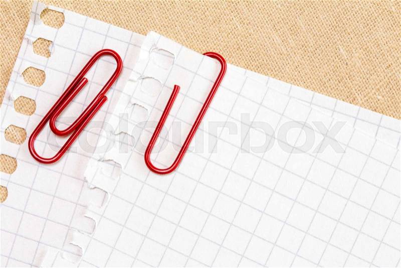 White paper sheet with red paper clips , stock photo
