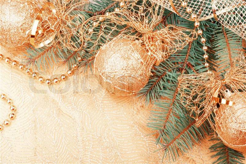 Gold Christmas ribbon, balls and beads on green pine branch. Old film stylized, stock photo