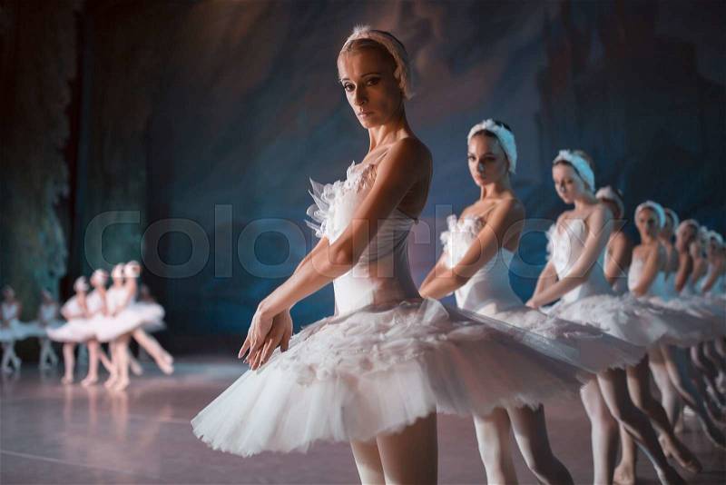 Dancers in white tutu synchronized dancing on stage. Repetition, editorial shooting, stock photo