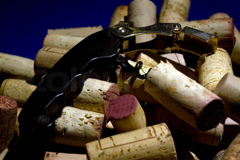 Wine corks with a waiters cork screw, stock photo