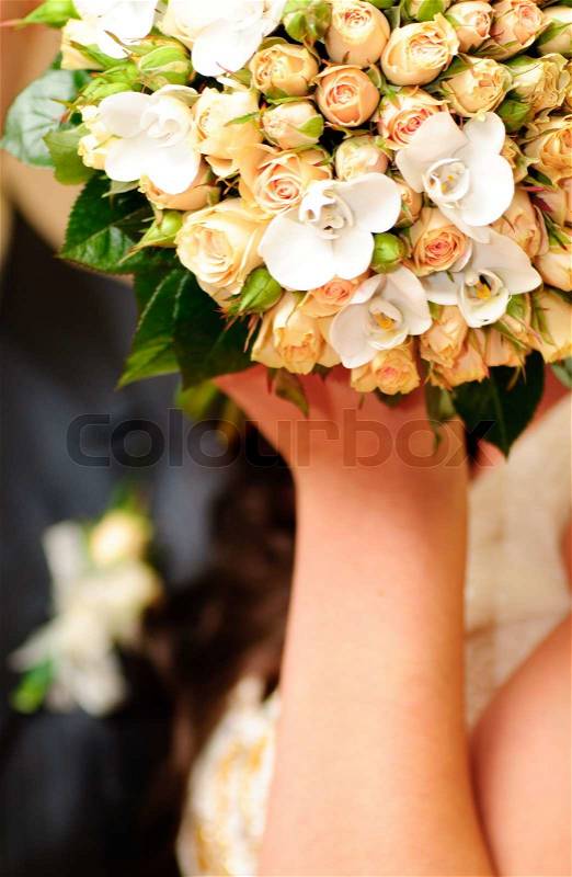 Wedding bouquet from peach-coloured roses and buds, stock photo
