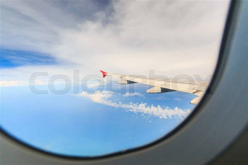 Scenery clouds and sky as seen through window of an aircraft, stock photo