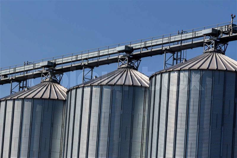 Silos for agricultural goods in a warehouse, stock photo